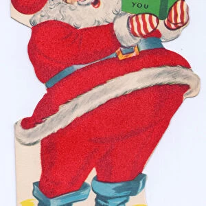 A die-cut Xmas Card of Father Christmas reading a book, his costume covered with red