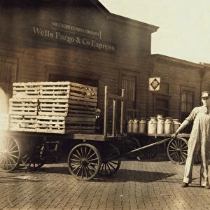 Men in front of a Wells Fargo & Co Express depot with crates and milk cans, Springfiled