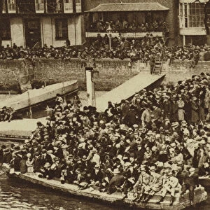 Spectators watching the Boat Race from barges on the Thames (b / w photo)