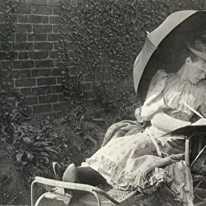 A woman writing on a sun lounger (b / w photo)