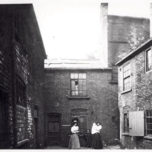 Two women pose with their children, Eagle and Child Yard, Hunslet, Leeds