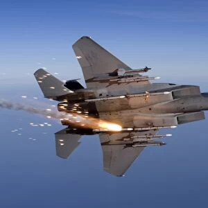An F-15 Eagle releases a flare while breaking hard to the left