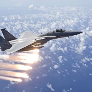 An F-15 Eagle releases flares over the Pacific Ocean