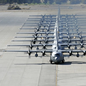 A line of C-130 Hercules taxi at Nellis Air Force Base, Nevada
