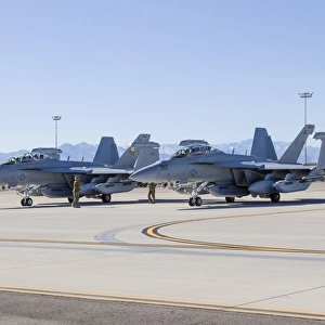 Two U. S. Navy E / A-18G Growlers make final checks prior to takeoff