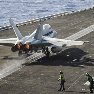 A U. S. Navy F / A-18C Hornet launches from the flight deck of USS Nimitz