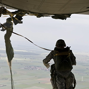 A U. S. soldier jumps out of a C-130J Super Hercules