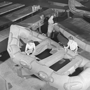 Women workers building assault boats for U. S. Marine Corps