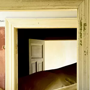 Abandoned house full of sand. Kolmanskop Ghost Town, an old diamond-mining town where