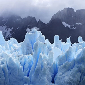Grey glacier with mountains in the background, Torres del Paine National Park, Patagonia