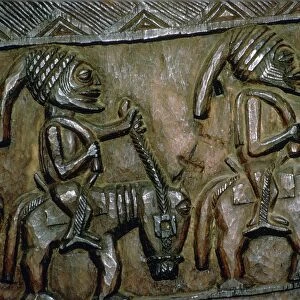 A carved wooden door from Nigeria depicting men on horseback