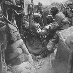 First aid to a wounded man in one of the French trenches, 1915