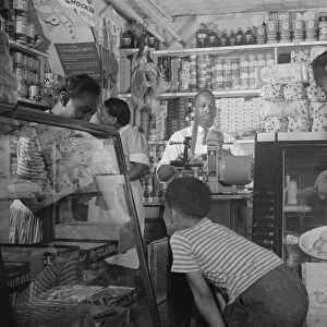 Grocery store owned by Mr. J. Benjamin, on Saturday afternoon, Washington, D. C. 1942. Creator: Gordon Parks