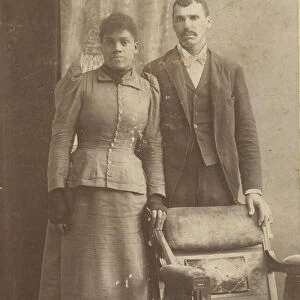 Photograph of an African-American couple standing behind a chair, ca. 1890