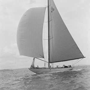 Sailing yacht Trivia running downwind under spinnaker, 1939. Creator: Kirk & Sons of Cowes