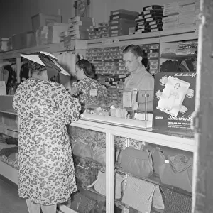 Shopper in a store at 7th Street and Florida Avenue, N. W. Washington, D. C. 1942. Creator: Gordon Parks