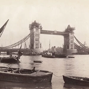 View of Tower Bridge under construction with river traffic in the foreground, London, c1893