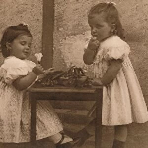 Two young girls by a table, 1937