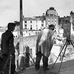 An artist painting the harbour in Tenby