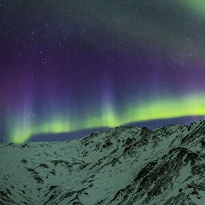 Aurora Borealis Over Mountains Within Denali National Park On A Very Cold Winter Night. The Andromeda Galaxy Is Visible To The Left; Alaska, United States Of America