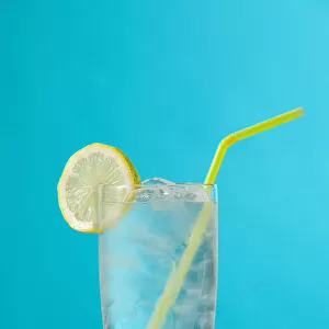 Clear Glass Of Water With Lemon And Drinking Straw