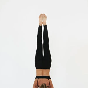 A woman doing a handstand on a white background; Tarifa cadiz andalusia spain