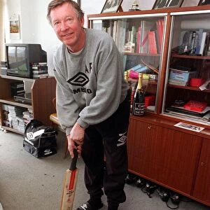 Alex Ferguson manager of Manchester United Football Club with a cricket bat