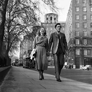 Artist couple Richard and Pat Larter walk around the streets of London
