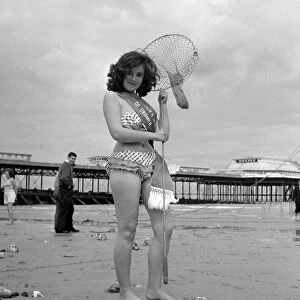 Beauty contest winner at Cromer, UK. seen here posing on the beach with net 26th