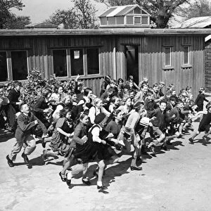 Children at school on the South East Coast of England, rush to their school shelter