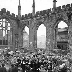 Crowds gather for a service inside the ruins of Coventry Cathedral after it was destroyed