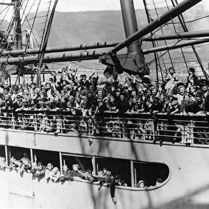 Evacuees from Great Britain wave to those on the quayside as they arrive in South Africa
