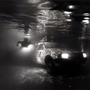 A Ford Escort in a swimming pool tests a new water repelant lubricant spray