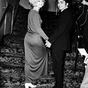 Goldie Hawn Actress holding hands with her husband Gus Trikonis at a film premiere in