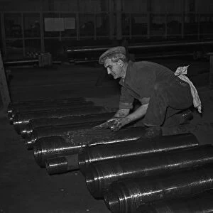 Gun barrels being greased before being attached to tanks under construction at the Royal