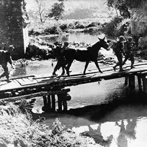US infantry of Mars Task Force cross temporary bridge in Burma during WW2