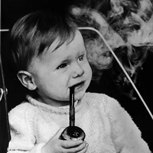 Lee Goult (17 months) smokes his cherrywood pipe, his father Allan Goult says he was