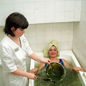 Lorraine Kelly Beauty treatment lying bath green mud being poured in