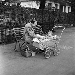 A man and child enjoying a picnic at London Zoo. 29th December 1954