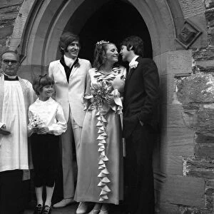 Mike McCartneys Wedding. A kiss for the bride from Paul McCartney watched by