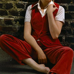 Model wearing a red velvet waistcoat and trousers with white hat, November 1969