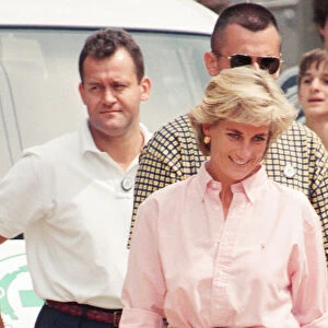 Paul Burrell (left, in the background in the white shirt and black trousers