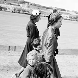 Queen Elizabeth ll May 1954 walking with Princess Anne while Prince Charles walks with