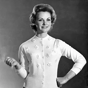 Reveille Fashions. Roma Reeves modeling a cardigan with embroided flower detail