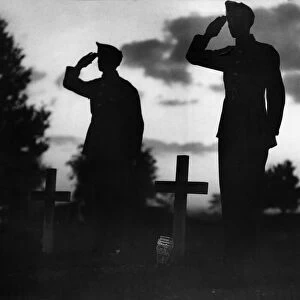 Soldiers salute at a cemetery as they remember comrades that died during the Battle