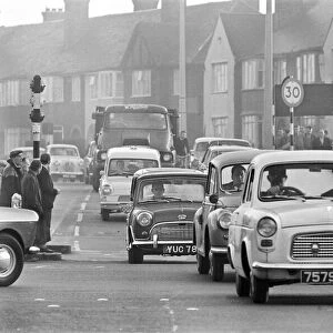 Traffic in High Street Dagenham as the Ford factory turns out at the end of the day shift