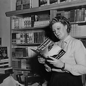 A woman reading a book about flying saucers 1950s