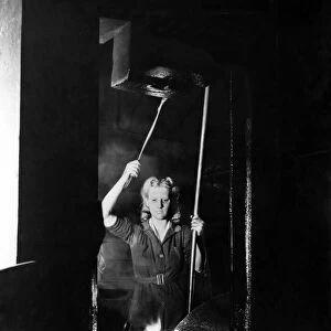 World War II Women. A woman operating a power hammer at the L. N. E. R. loco works
