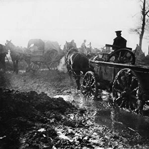 World War One - A soldier drives a horse and supply cart through water logged fields