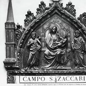 Madonna and Child with St. John the Baptist and St. Mark, lunette above the doorway leading to Campo San Zaccaria in Venice